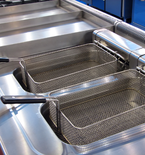 Technician deep cleaning a commercial griddle