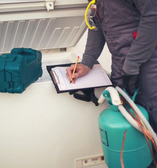 Technician performing maintenance on commercial freezer in Dubai